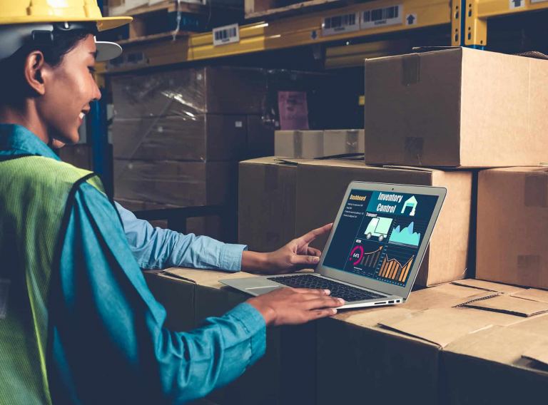 Factory-worker-looking-at-computer-with-real-time-inventory